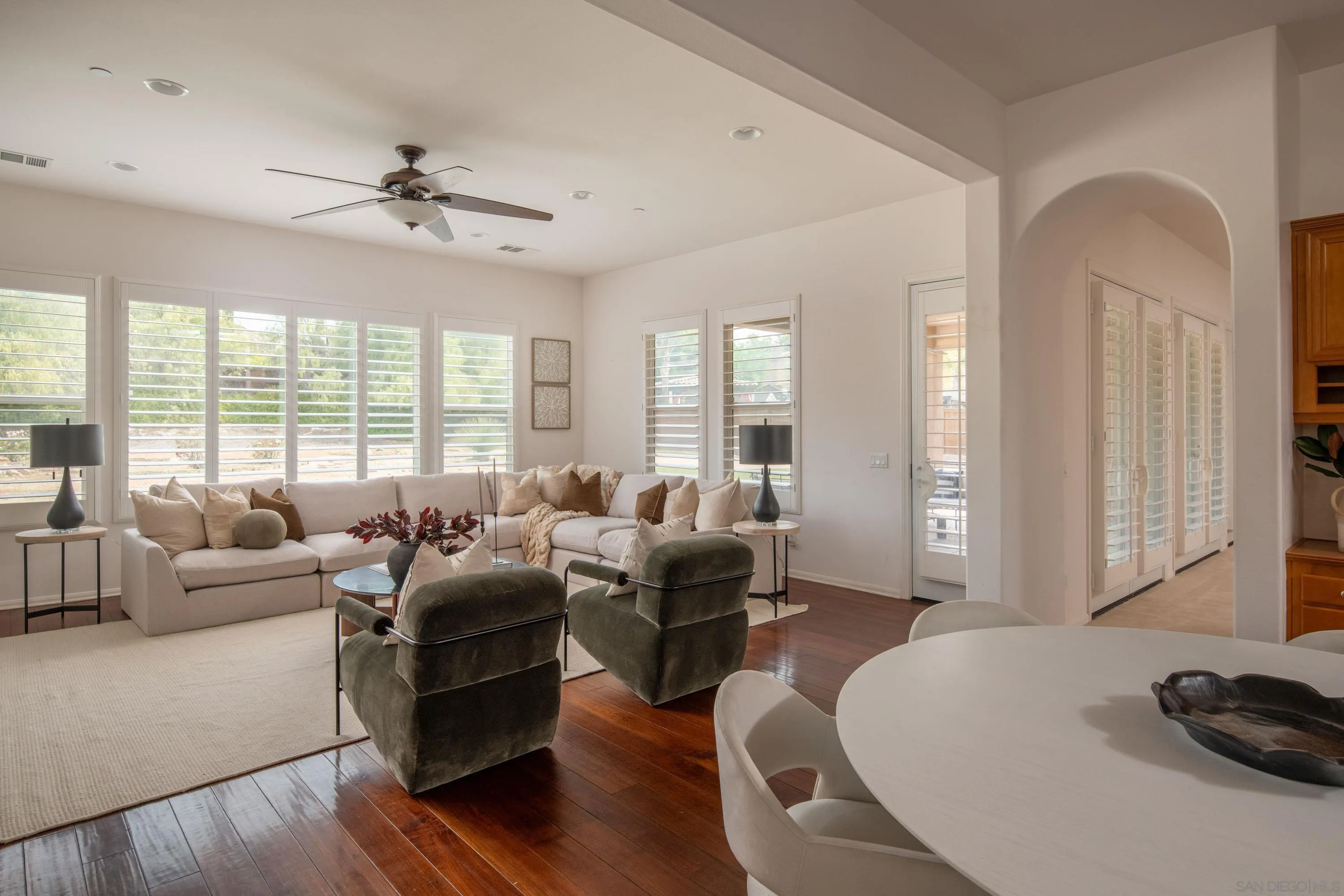 14220 Pebble Beach Way Valley Center, CA 92082 - Photo 3 of 48 a living room with furniture floor to ceiling window and wooden floor