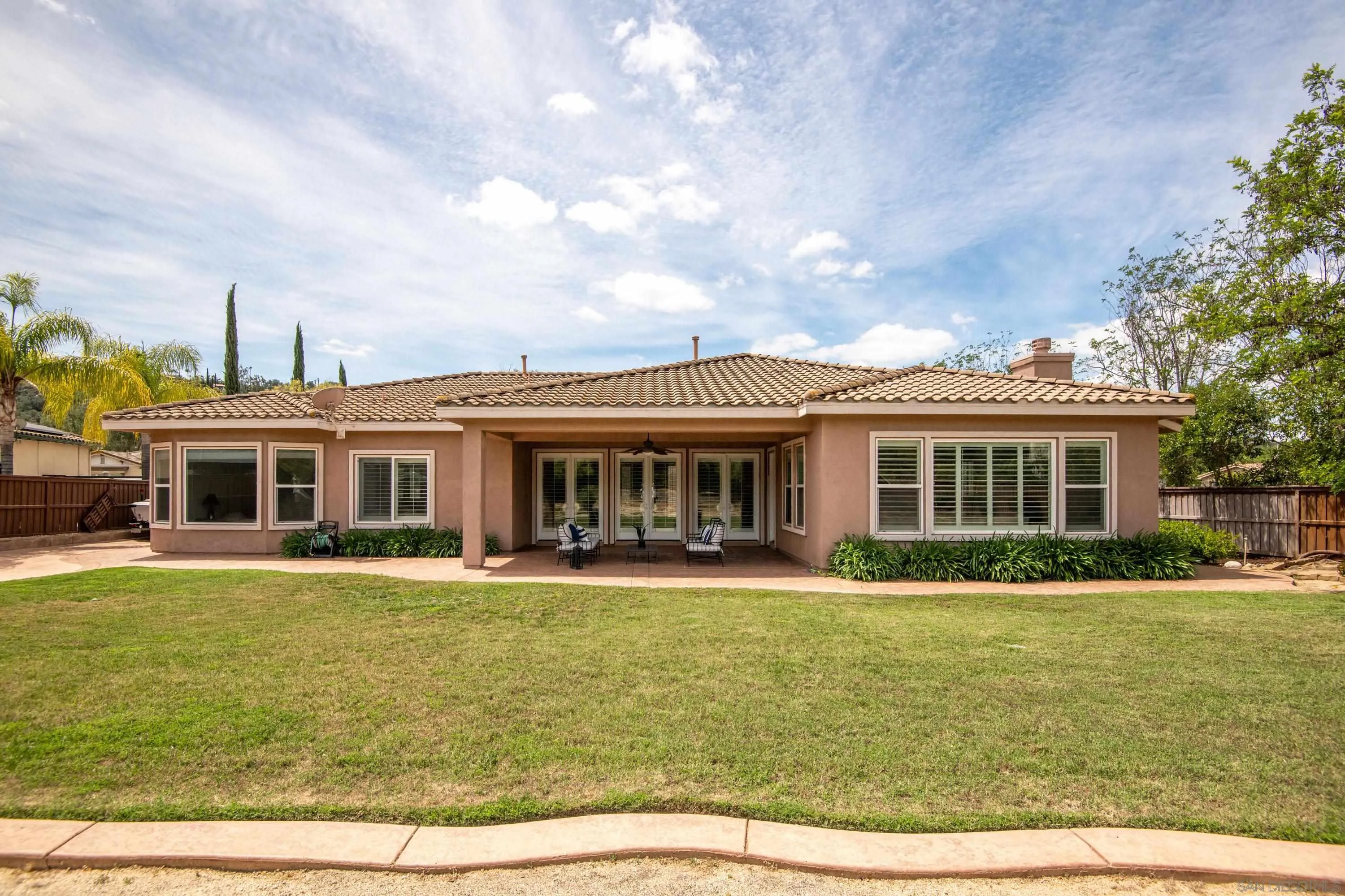 14220 Pebble Beach Way Valley Center, CA 92082 - Photo 34 of 48 a front view of a house with a garden