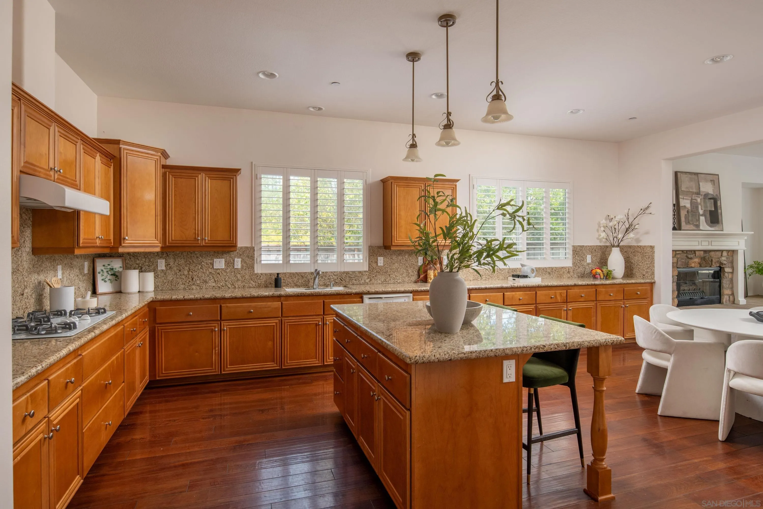 14220 Pebble Beach Way Valley Center, CA 92082 - Photo 6 of 48 a kitchen with stainless steel appliances granite countertop a sink a stove and kitchen island