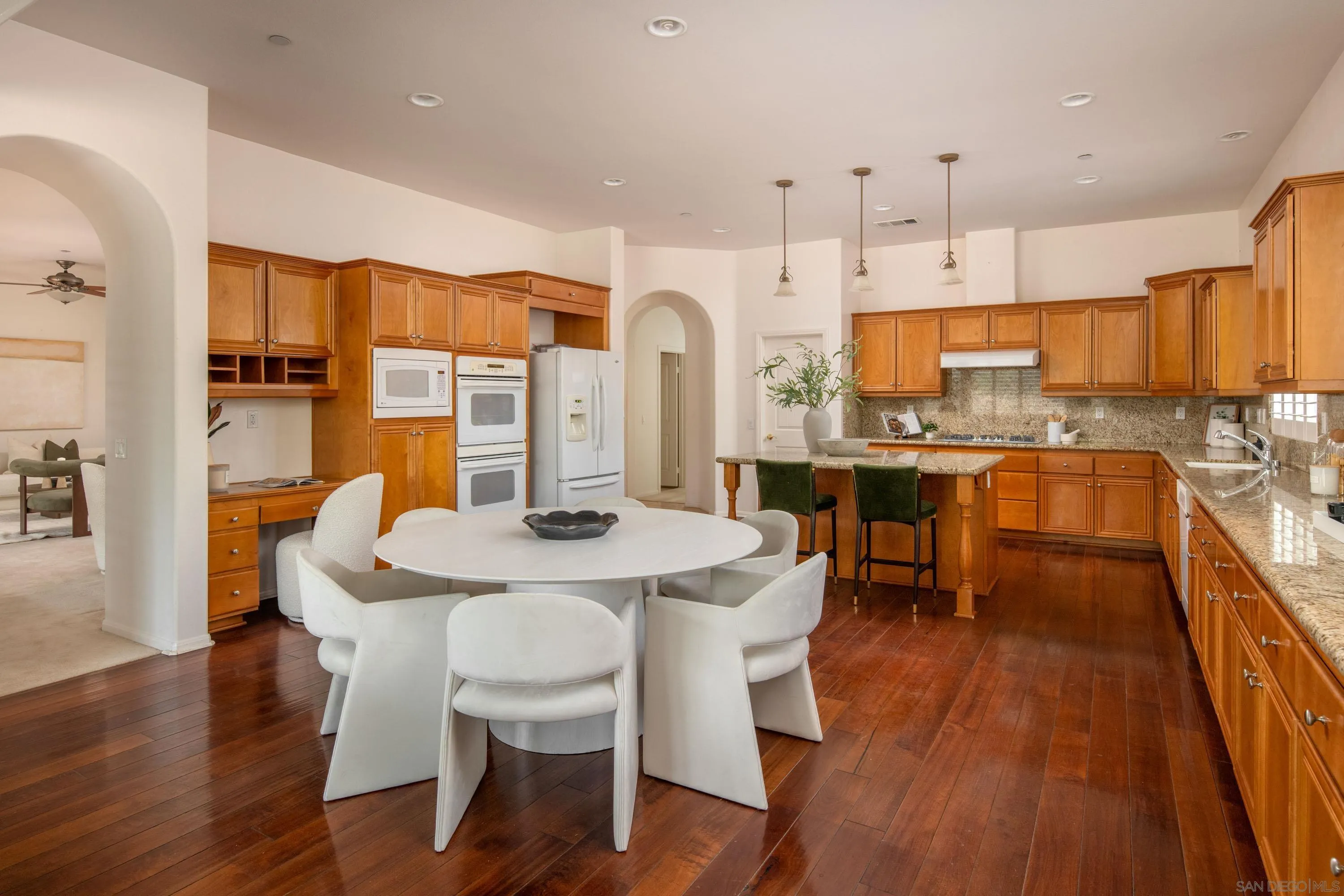 14220 Pebble Beach Way Valley Center, CA 92082 - Photo 7 of 48 a view of kitchen with cabinets table and chairs