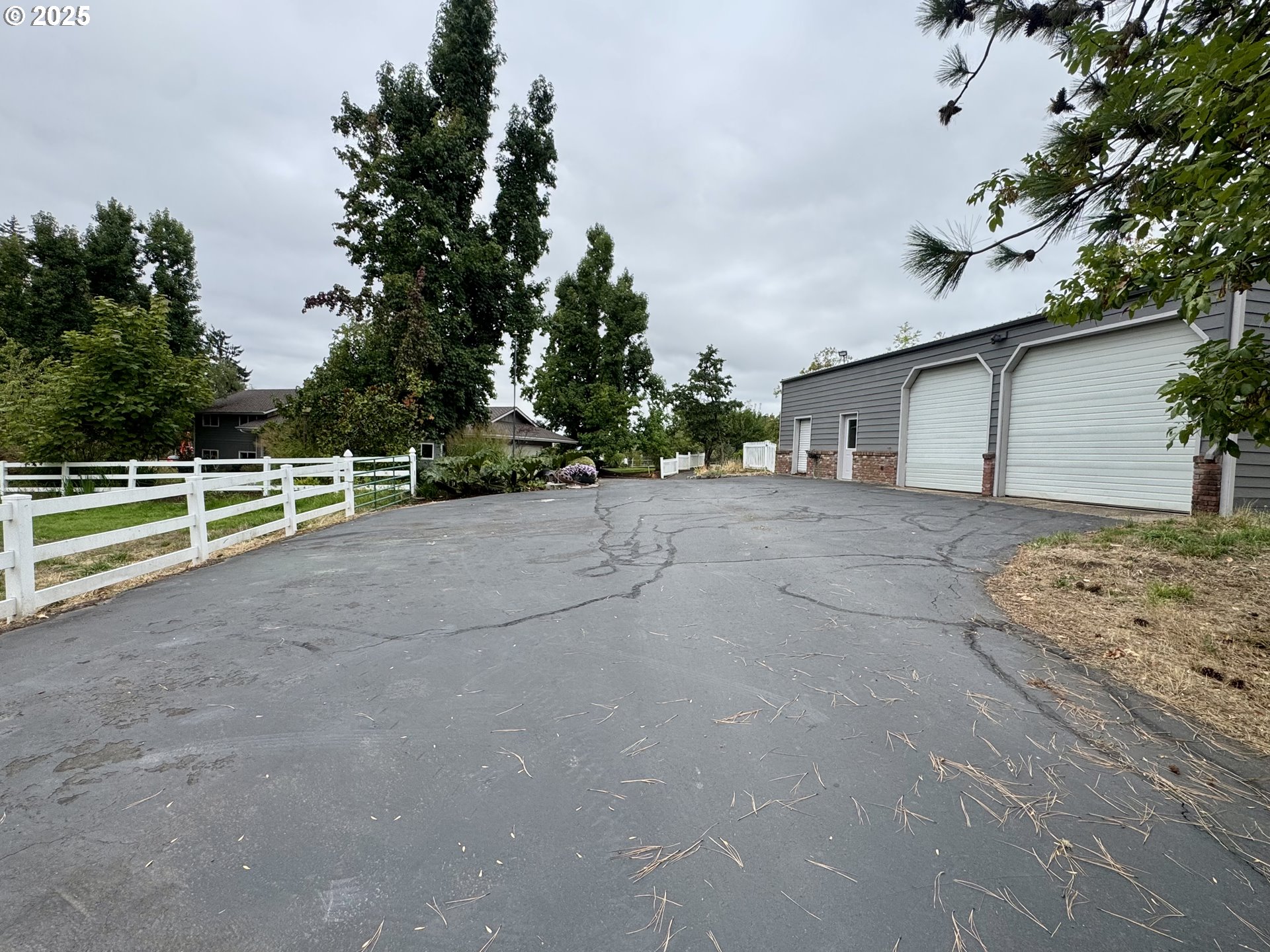 35929 Enterprise Road Creswell, OR 97426 - Photo 13 of 48 a view of a house with a large tree and wooden fence