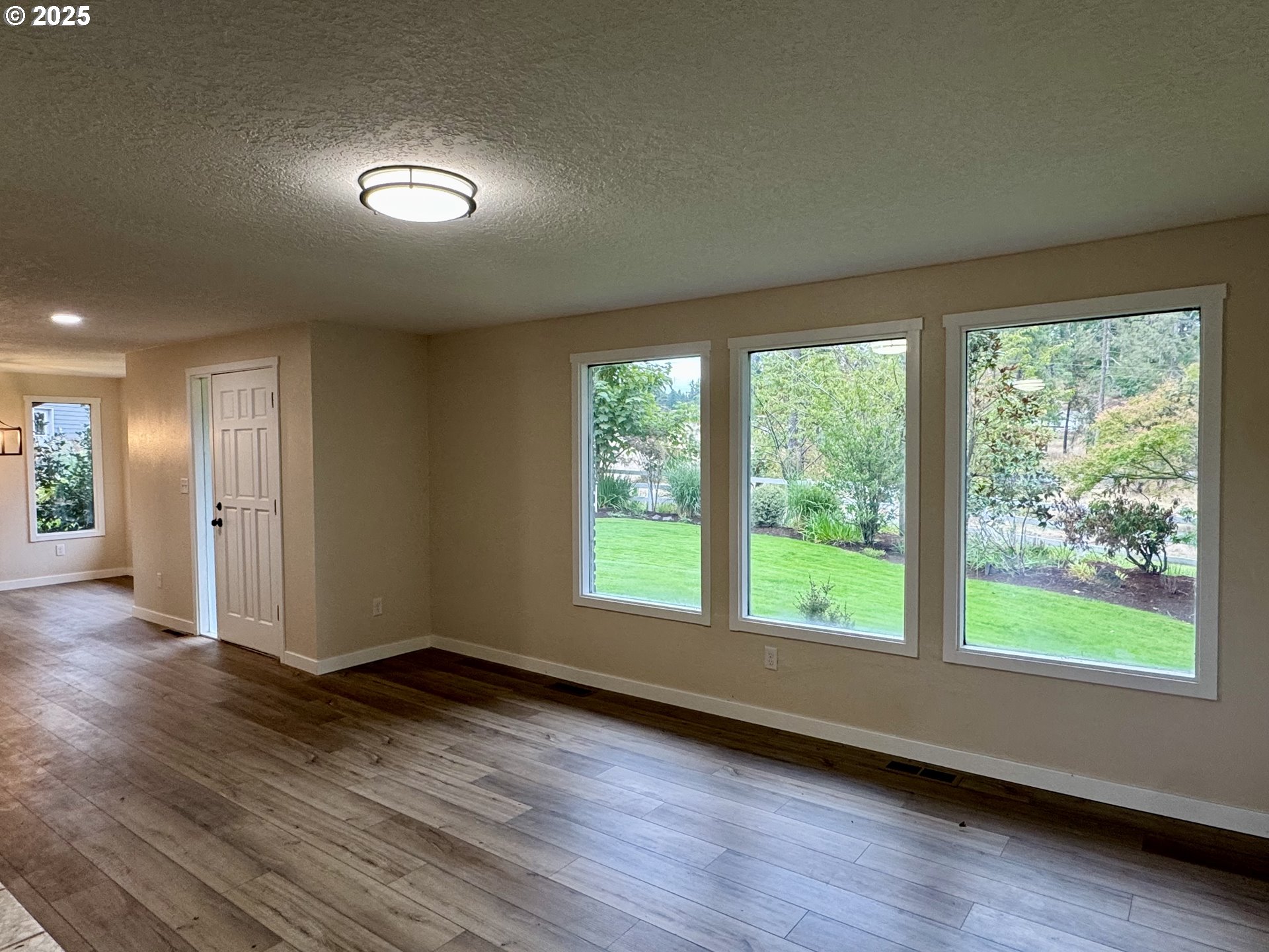 35929 Enterprise Road Creswell, OR 97426 - Photo 20 of 48 a view of an empty room with wooden floor and a window