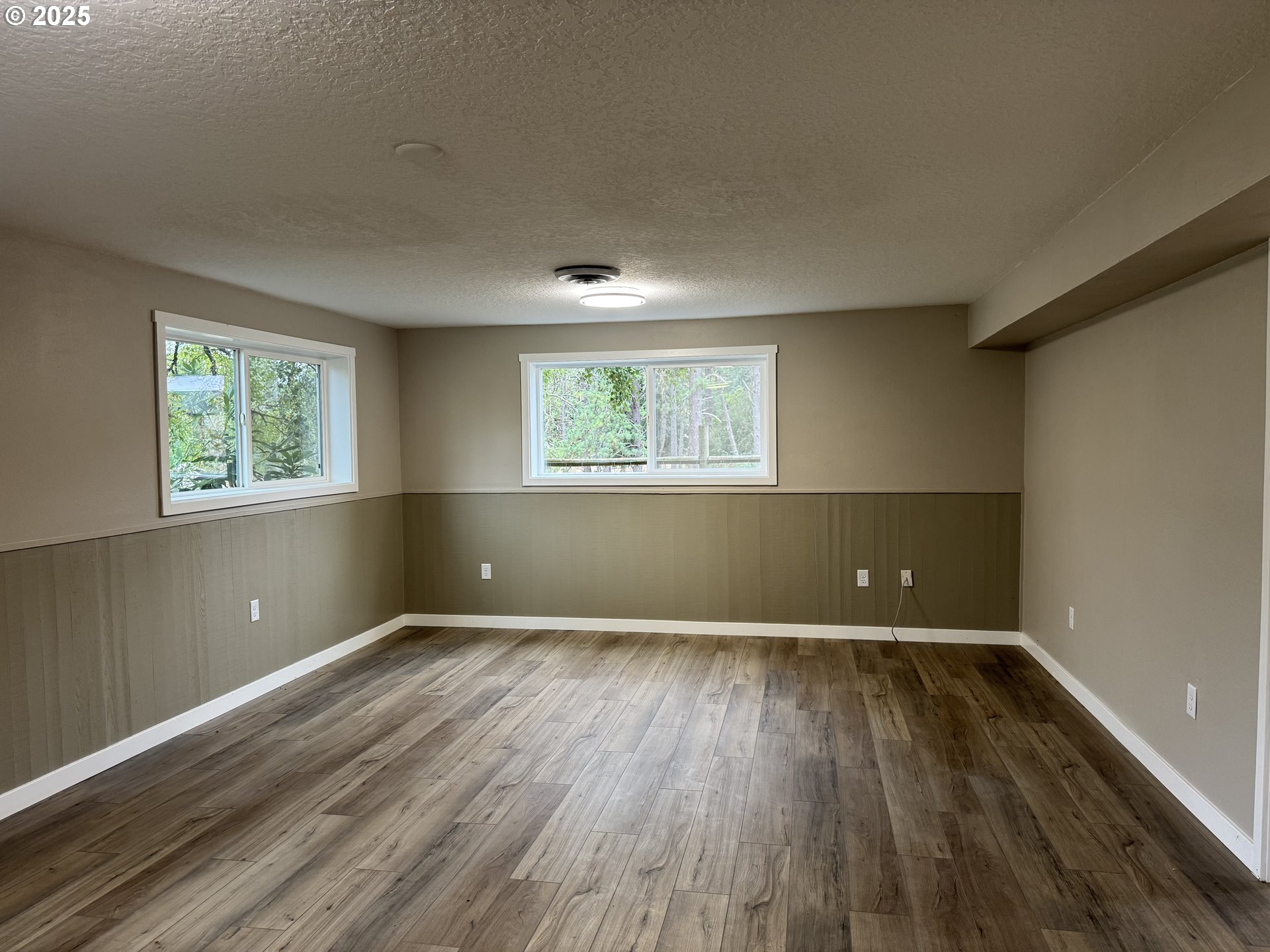 35929 Enterprise Road Creswell, OR 97426 - Photo 44 of 48 an empty room with wooden floor and windows
