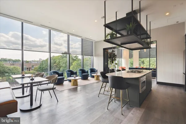 a living room with furniture a lamp and a floor to ceiling window