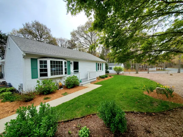 a view of backyard of house with green space