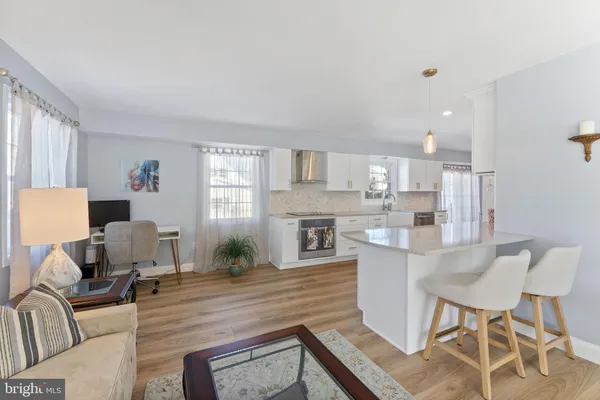 a living room with fireplace furniture and a wooden floor