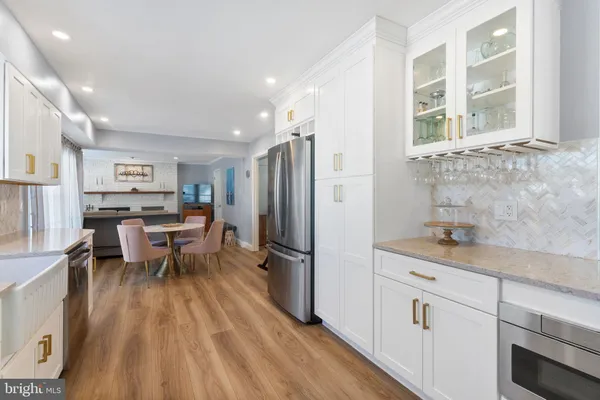 a kitchen with a sink appliances and cabinets