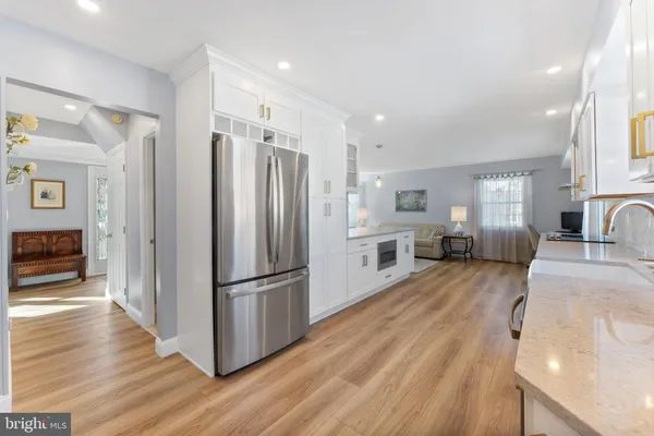 a kitchen with stainless steel appliances a refrigerator and a stove top oven