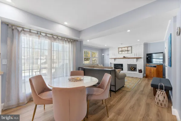 a living room with fireplace furniture and a large window