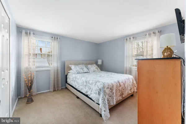 a bedroom with a bed couch and a window