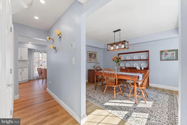 a dining room with a wooden table and chairs