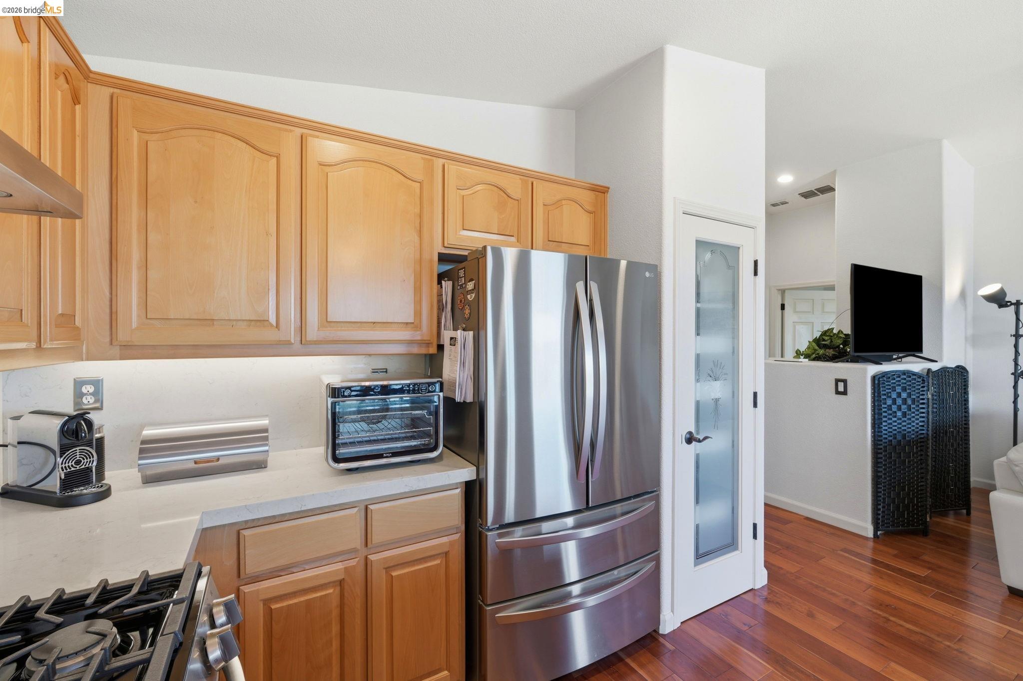1024 Diamante Rio Vista, CA 94571 - Photo 11 of 27 Kitchen featuring natural wood cabinetry, light-toned countertops, stainless steel appliances, and under-cabinet lighting