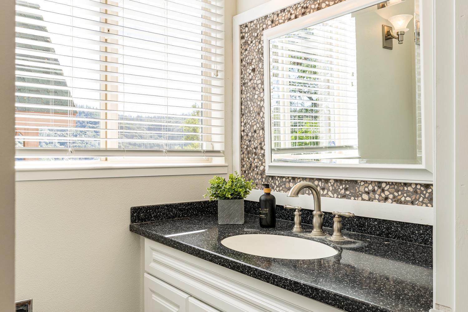 2213 Old Toll Road Placerville, CA 95667 - Photo 23 of 77 a bathroom with a granite countertop sink and a mirror
