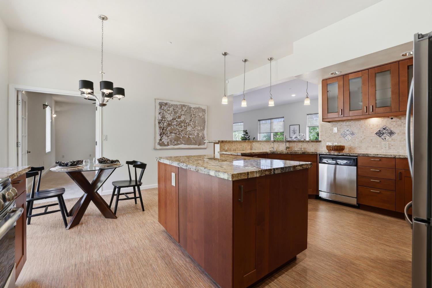 2213 Old Toll Road Placerville, CA 95667 - Photo 66 of 77 a kitchen with kitchen island granite countertop wooden floors and a view of living room