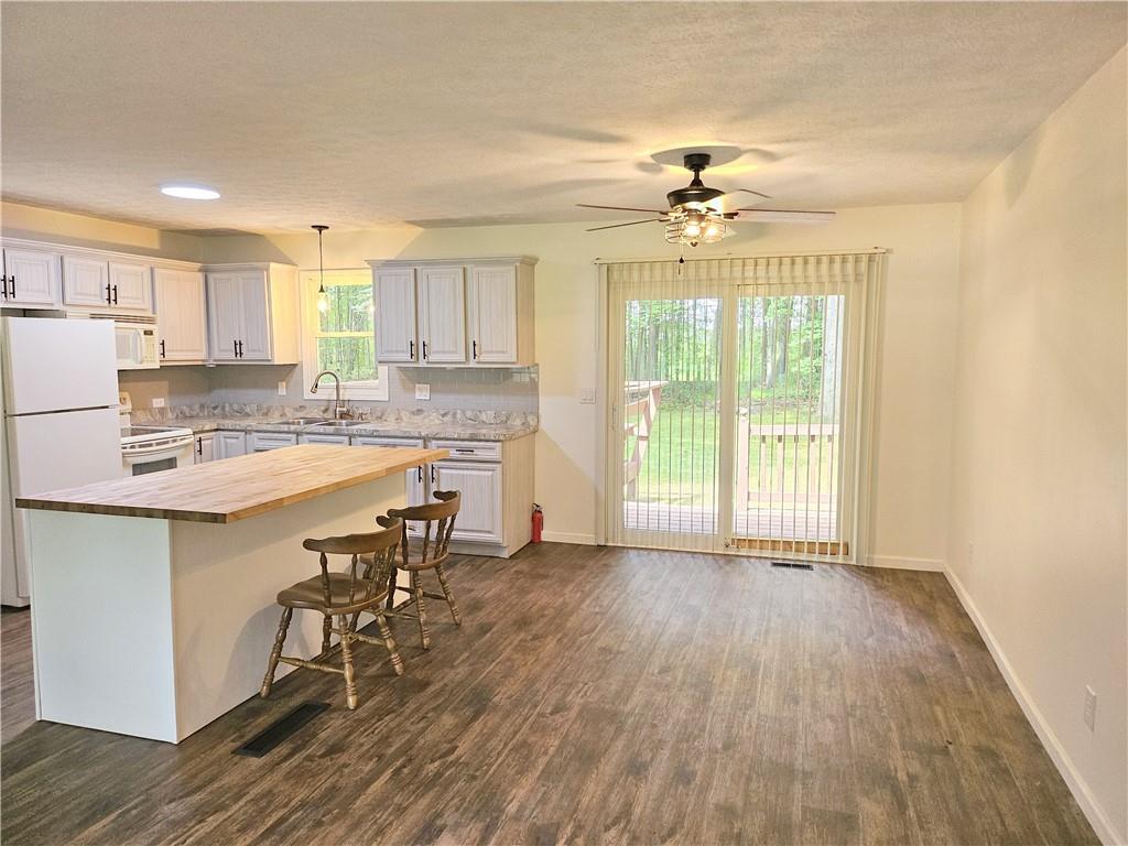 139 Sunset Road Grove City, PA 16127 - Photo 13 of 48 a living room with stainless steel appliances granite countertop furniture wooden floor and a kitchen view