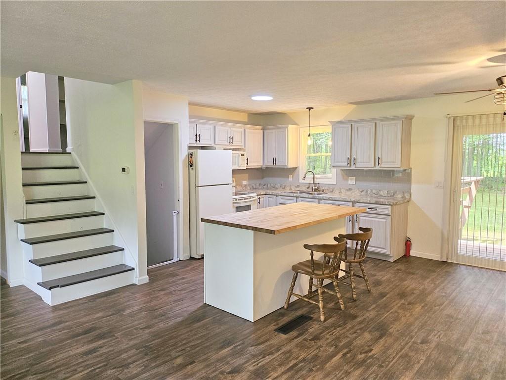 139 Sunset Road Grove City, PA 16127 - Photo 14 of 48 a kitchen with a table chairs refrigerator and window