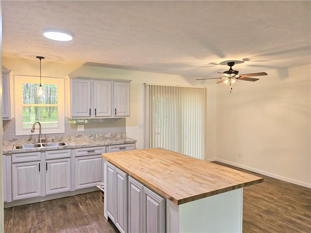 139 Sunset Road Grove City, PA 16127 - Photo 16 of 48 a kitchen with a sink cabinets and wooden floor