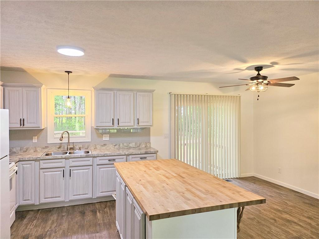139 Sunset Road Grove City, PA 16127 - Photo 17 of 48 a kitchen with a stove a sink and a refrigerator