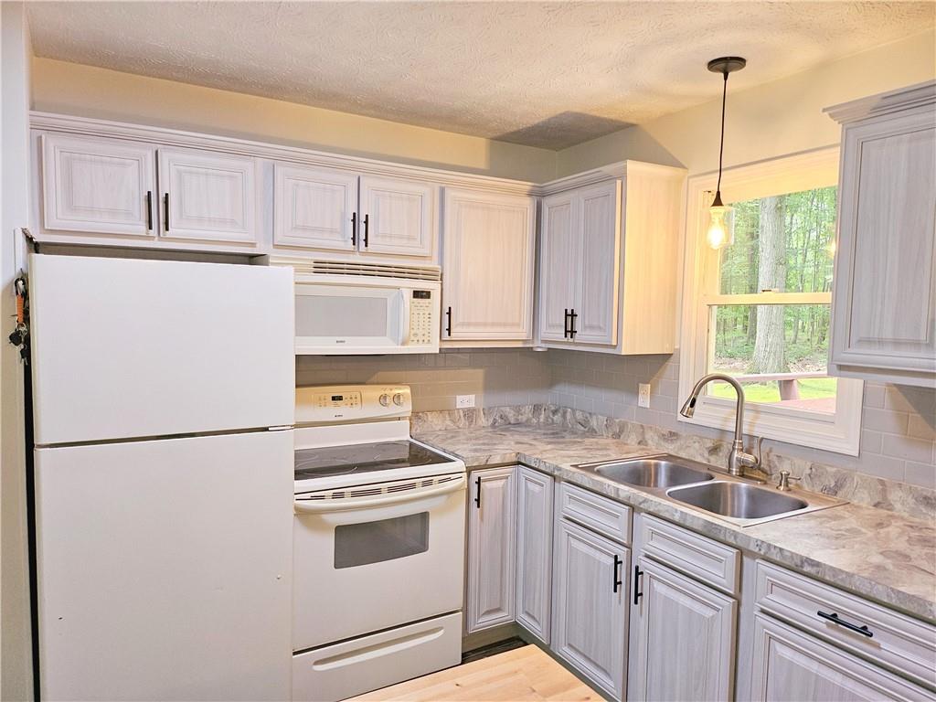 139 Sunset Road Grove City, PA 16127 - Photo 20 of 48 a kitchen with appliances cabinets and a sink