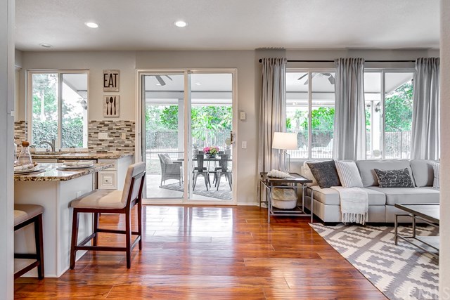 24 Silveroak Irvine, CA 92620 - Photo 11 of 49 a living room with furniture and large windows