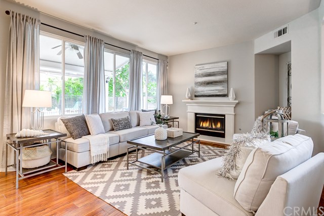 24 Silveroak Irvine, CA 92620 - Photo 12 of 49 a living room with furniture a large window and a fireplace