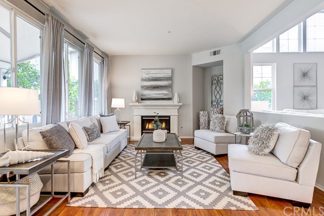 24 Silveroak Irvine, CA 92620 - Photo 13 of 49 a living room with furniture fireplace and large windows