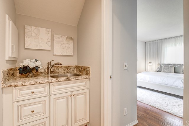 24 Silveroak Irvine, CA 92620 - Photo 23 of 49 a en suite bathroom with a granite countertop sink and a mirror