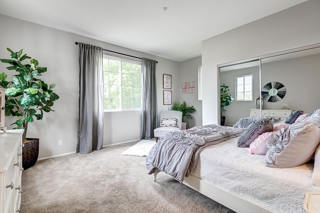 24 Silveroak Irvine, CA 92620 - Photo 27 of 49 a bedroom with bed and a potted plant