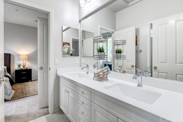 24 Silveroak Irvine, CA 92620 - Photo 30 of 49 a bathroom with double vanity sink and a mirror