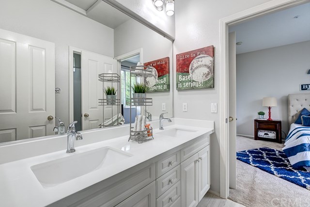 24 Silveroak Irvine, CA 92620 - Photo 32 of 49 a bathroom with a double vanity sink and a mirror