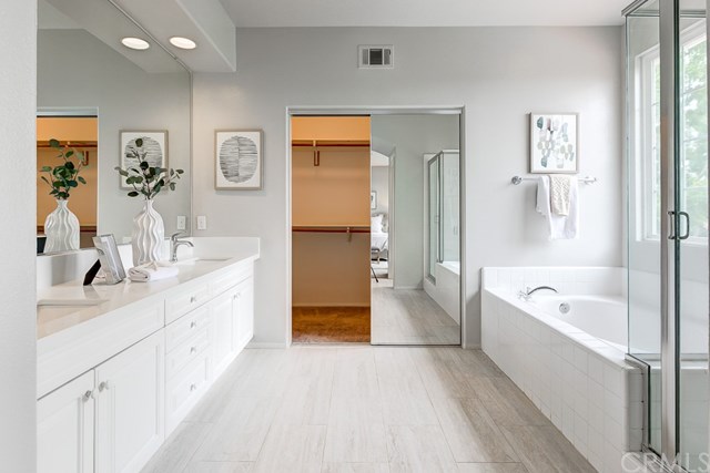24 Silveroak Irvine, CA 92620 - Photo 36 of 49 a spacious bathroom with a tub sink and mirror
