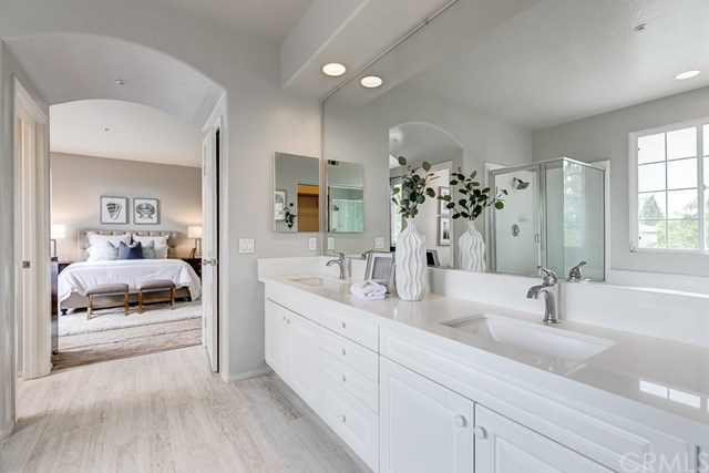 24 Silveroak Irvine, CA 92620 - Photo 39 of 49 a en suite bathroom with double sink and a mirror