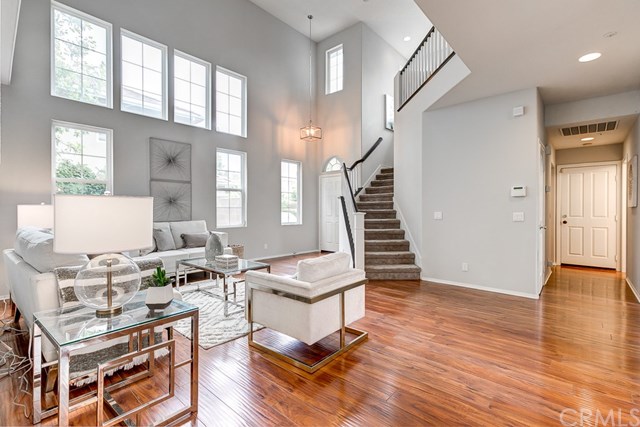 24 Silveroak Irvine, CA 92620 - Photo 7 of 49 a living room with lots of furniture and a wooden floor