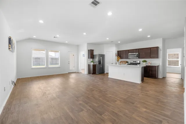 a view of a kitchen with a sink stove cabinets and a kitchen