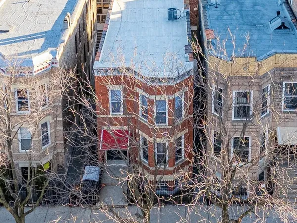 an aerial view of a brick building with many windows