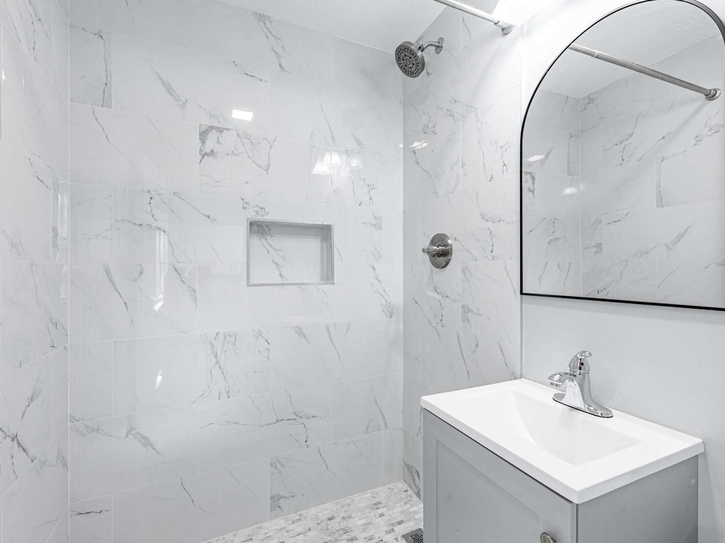 1621 West Cullerton Street, Unit 2 Chicago, IL 60608 - Photo 12 of 17 a bathroom with a sink mirror and shower