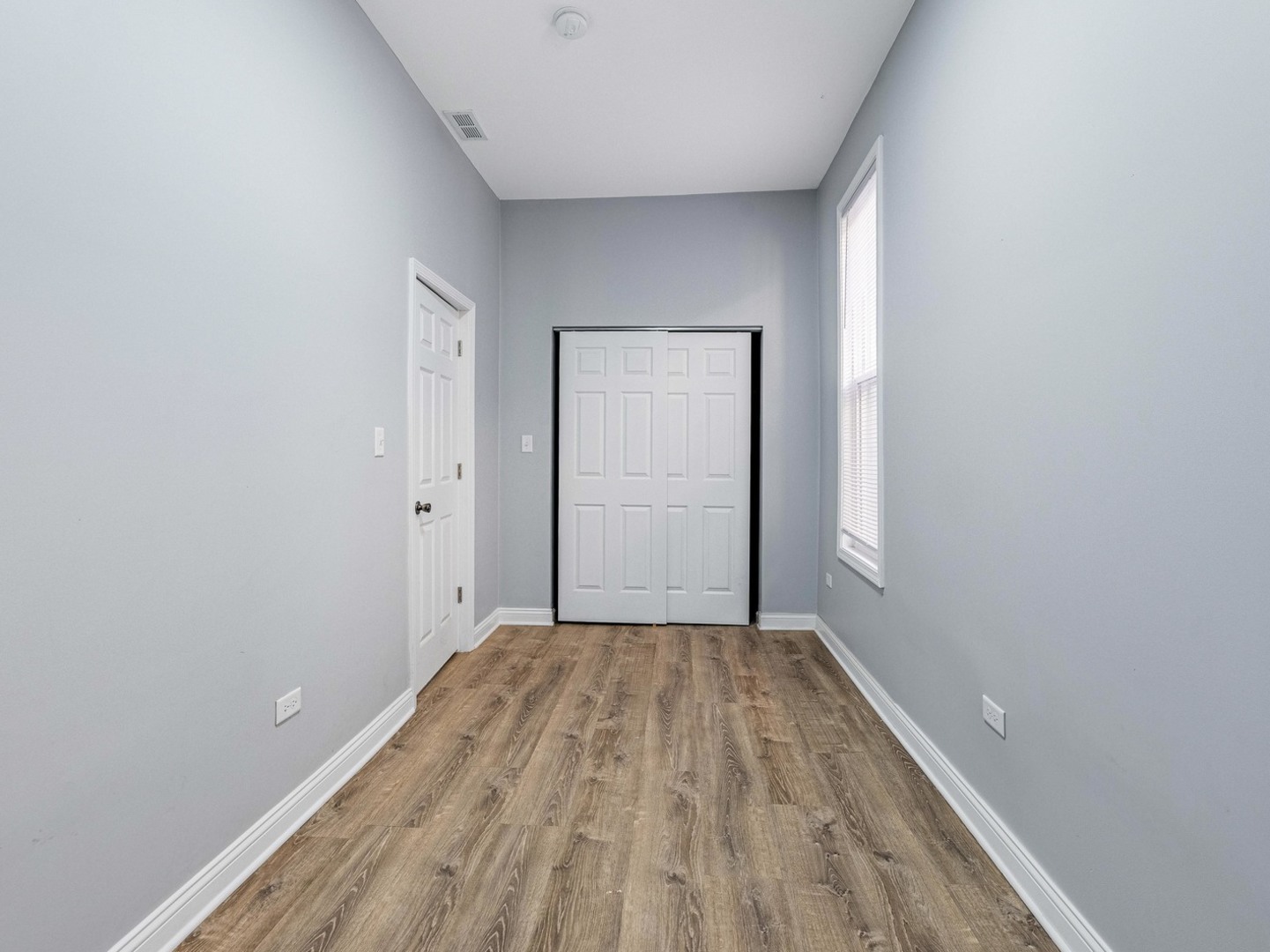 1621 West Cullerton Street, Unit 2 Chicago, IL 60608 - Photo 14 of 17 a view of a room with a wooden floor and white doors