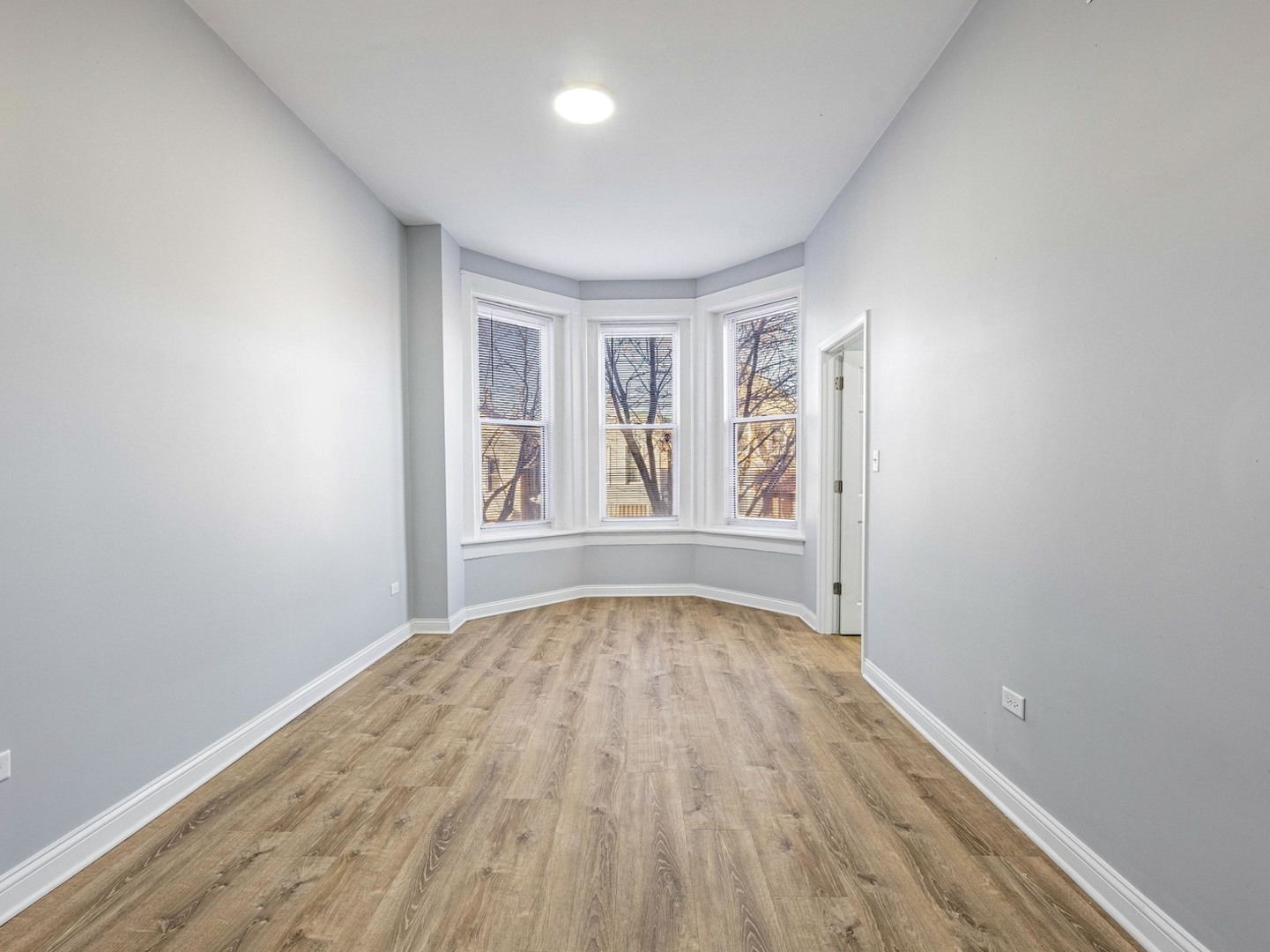 1621 West Cullerton Street, Unit 2 Chicago, IL 60608 - Photo 2 of 17 wooden floor in an empty room with a window
