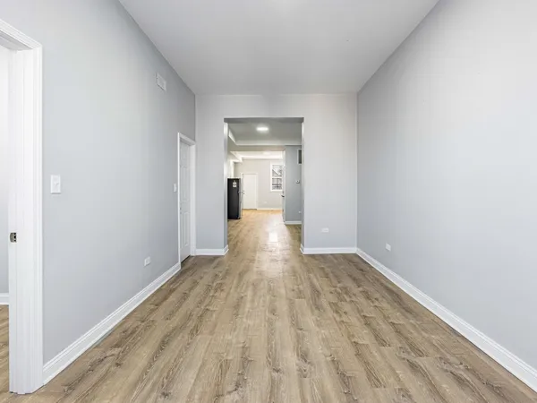 a view of a room with wooden floor