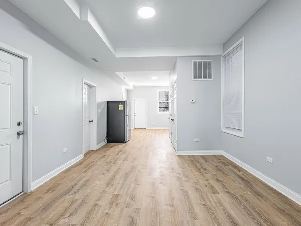 a view of empty room with wooden floor