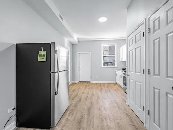a view of hallway with wooden floor and stairs