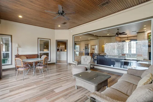a living room with furniture a wooden floor and chandelier