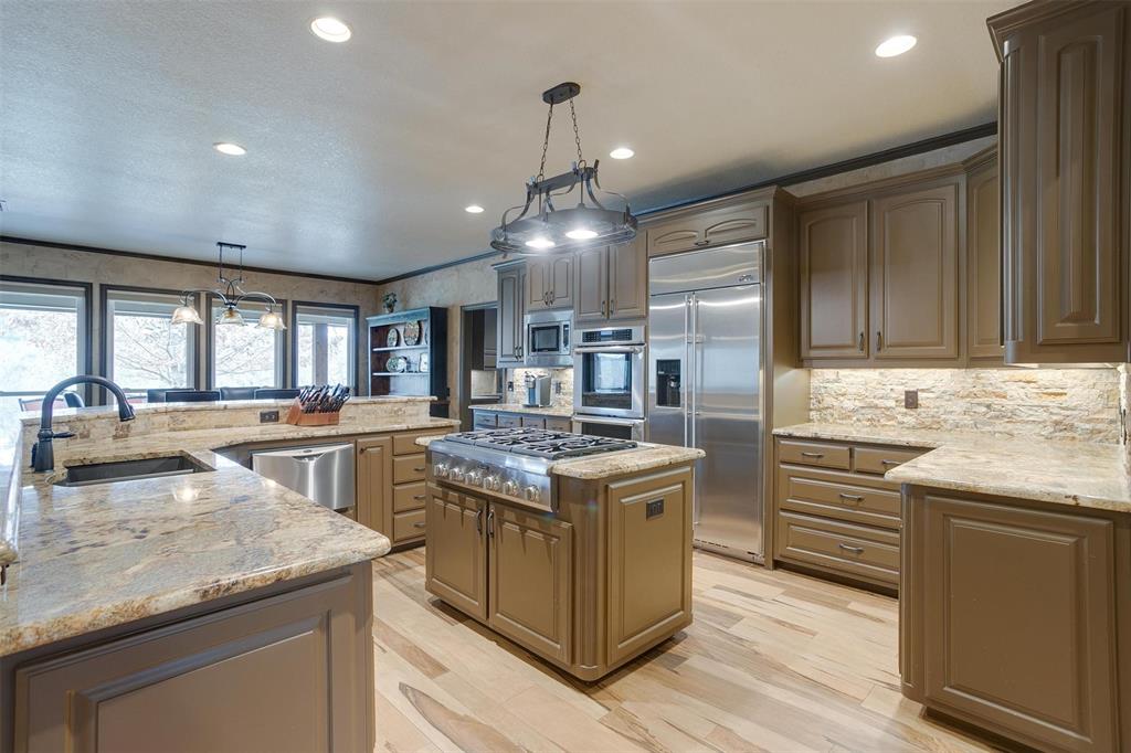 9310 Bellechase Road Granbury, TX 76049 - Photo 13 of 39 a kitchen with a stove and a sink