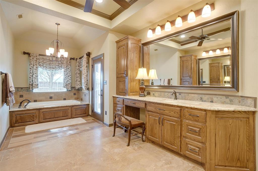 9310 Bellechase Road Granbury, TX 76049 - Photo 16 of 39 a large spacious bathroom with a granite countertop tub double vanity sink a mirror and a shower
