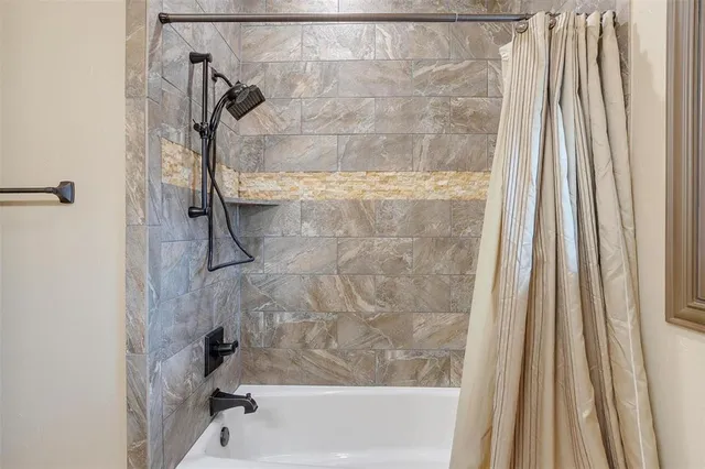 a bath tub sitting next to a white sink and a shower