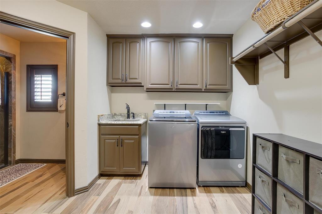 9310 Bellechase Road Granbury, TX 76049 - Photo 23 of 39 a kitchen with stainless steel appliances granite countertop a stove a sink and a refrigerator