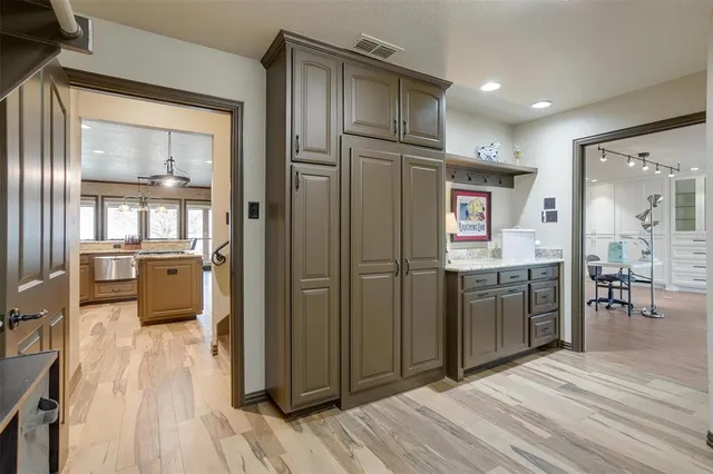 a kitchen with stainless steel appliances a refrigerator and wooden floor