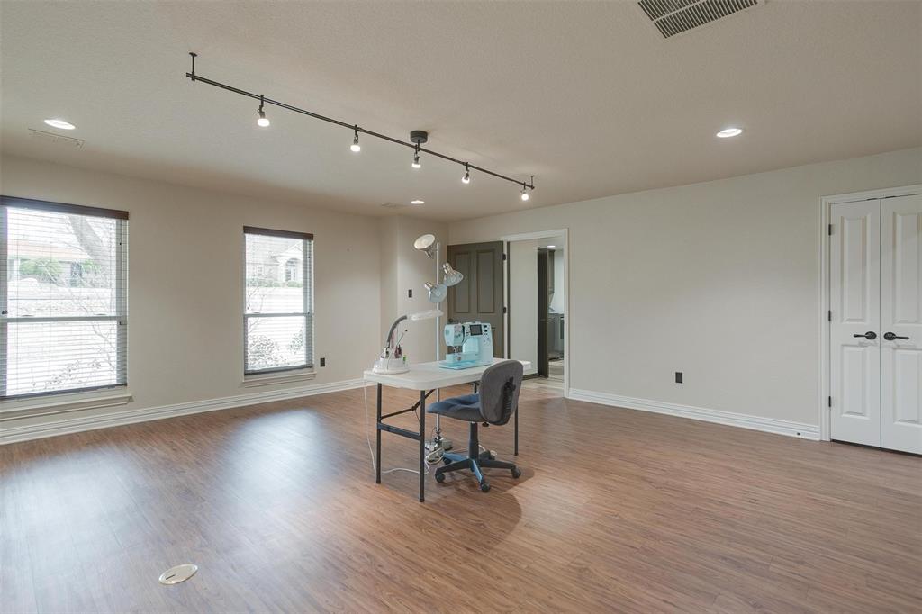 9310 Bellechase Road Granbury, TX 76049 - Photo 25 of 39 a workspace with wooden floor and white walls