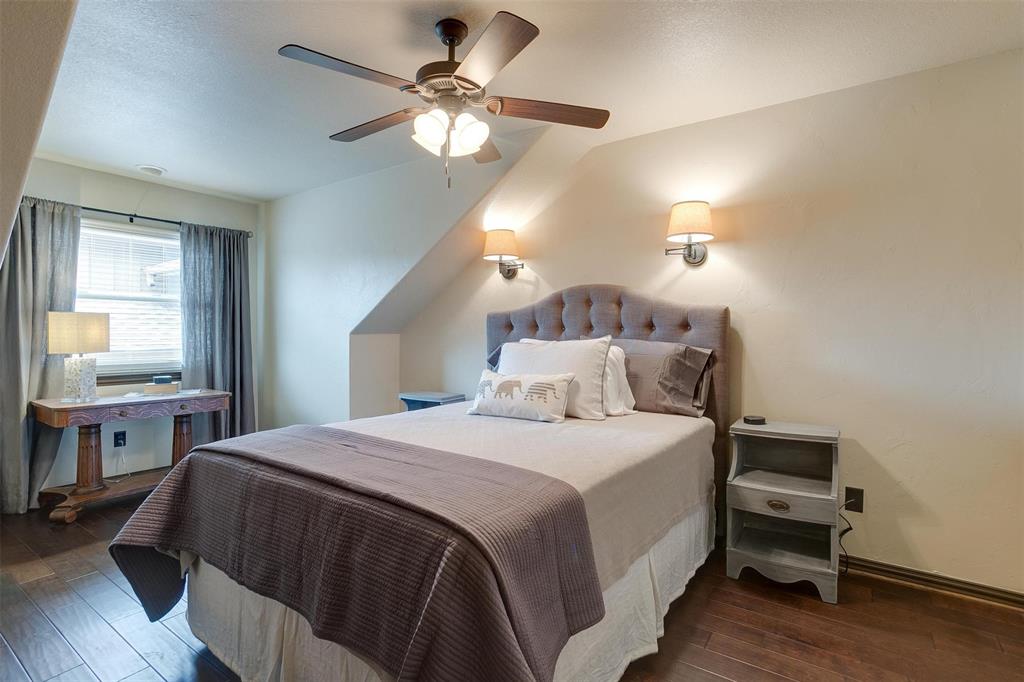 9310 Bellechase Road Granbury, TX 76049 - Photo 29 of 39 a bedroom with a bed and a chandelier