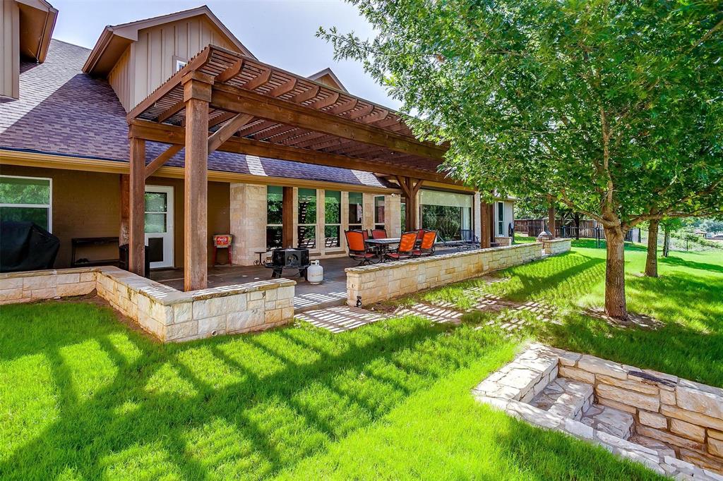 9310 Bellechase Road Granbury, TX 76049 - Photo 35 of 39 a view of a house with a backyard porch and sitting area